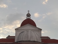 Photo of a church dome against a blue sky at sunset